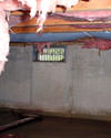 Tennessee and Kentucky crawl space with vents, showing mold, rot, and fiberglass insulation dripping off the ceiling.