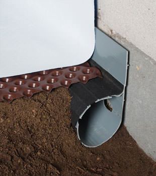 Closeup of a crawl space drainage system installed in Sparta