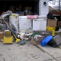 Soaked, wet personal items sitting in a driveway, including a washer and dryer in Oak Ridge.
