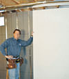 Installing wall panels on top of our basement wall insulation in Oak Ridge
